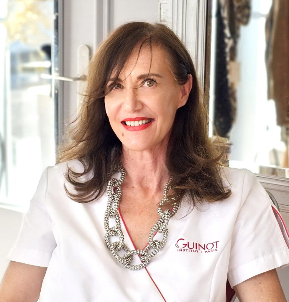 Femme souriante en blouse de beauté, représentante de l'Institut privilège.